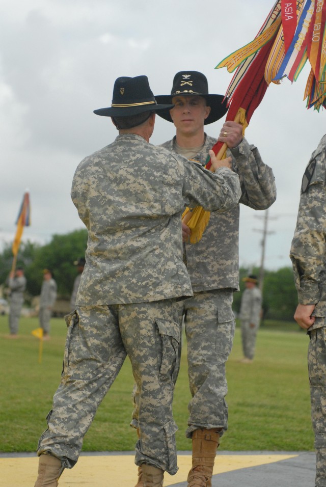 FORT HOOD, Texas - Rock Island, Ill. native, Col. Scott Efflandt (right), commander of the 1st Brigade Combat Team, 1st Cavalry Division, receives the colors from Maj. Gen. Daniel Allyn, the 1st Cav. Div. commander, during the change of command...