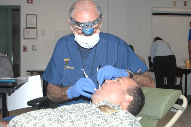 Dentist examines teeth at muster