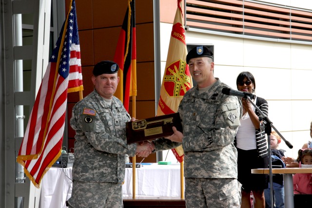 Maj. John Drew (right), deputy commander of the U.S. Army Corps of Engineers Europe District, hands over the ceremonial key plaque to Col. Jeffrey Dill, U.S. Army Garrison Wiesbaden commander, during a ribbon-cutting ceremony April 29, 2010,...