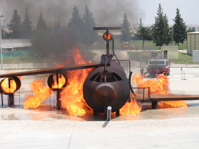 In this 2007 file photo, firefighter trainees put out a fuselage fire on a mock C-130. A similar facility is under construction at Ramstein Air Base in Germany that will provide live fire training capabilities to the U.S. Air Force's in Europe...