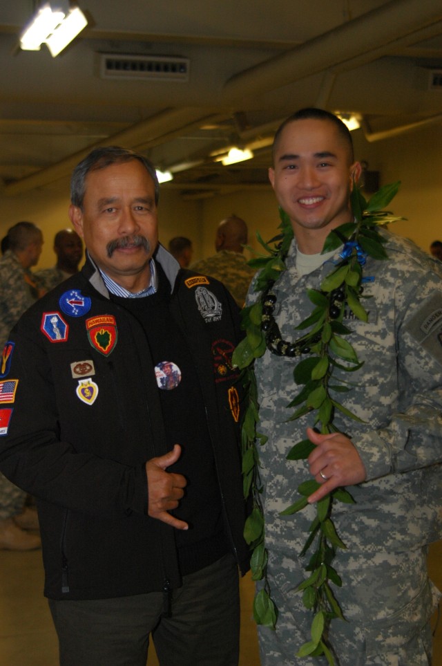 FORT WAINWRIGHT, Alaska - Allen Hoe, father of 1st Lt. Nainoa Hoe, fallen Soldier from 3rd Battalion, 21st Infantry Regiment, 1st Stryker Brigade Combat Team, 25th Infantry Division, congratulates Capt. Michael Tiongco, incoming B Company, 3-21st,...