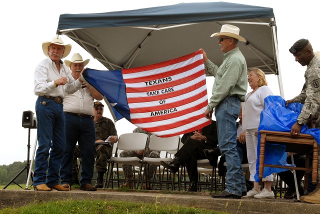 CENTERVILLE, Texas-Richard Wallrath (left), owner of the Champion Ranch, accepts a gift of appreciation for donating the use of his land during the annual Veteran Appreciation Day hosted by the 41st Fires Brigade and Leon County Veterans Service...