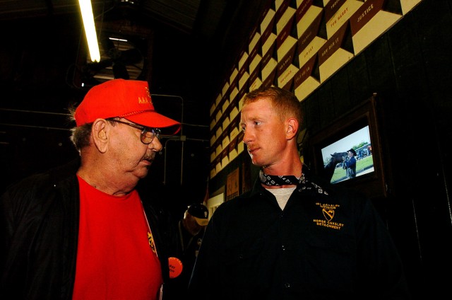 FORT HOOD, Texas-Sgt. Red Donaldson (right), a Horse Cavalry Detachment trooper from Gatesville, Texas, speaks with Ray Murray, of Wire, Ky., during the 865th Anti-Aircraft Artillery Battalion reunion April 29, at Fort Hood, Texas. Murray served with...