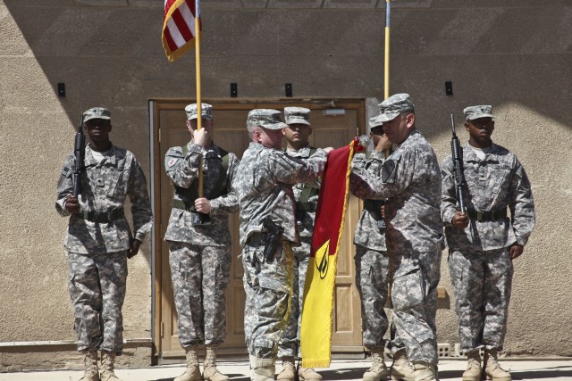 CAMP TAJI, Iraq—Col. Douglas Gabram (center), from Cleveland, commander, 1st Air Cavalry Brigade, 1st Cavalry Division, cases the brigade colors with Command Sgt. Maj. Glen Vela (second from right), from Dallas, brigade command sergeant major,...