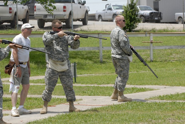 FORT HOOD, Texas- Spc. Robert Looney (center), a cannon crewmember assigned to the 5th Battalion, 82nd Field Artillery Regiment, 4th Brigade Combat Team, 1st Cavalry Division, partakes in clay shooting along with other Soldiers in his unit, here, May...