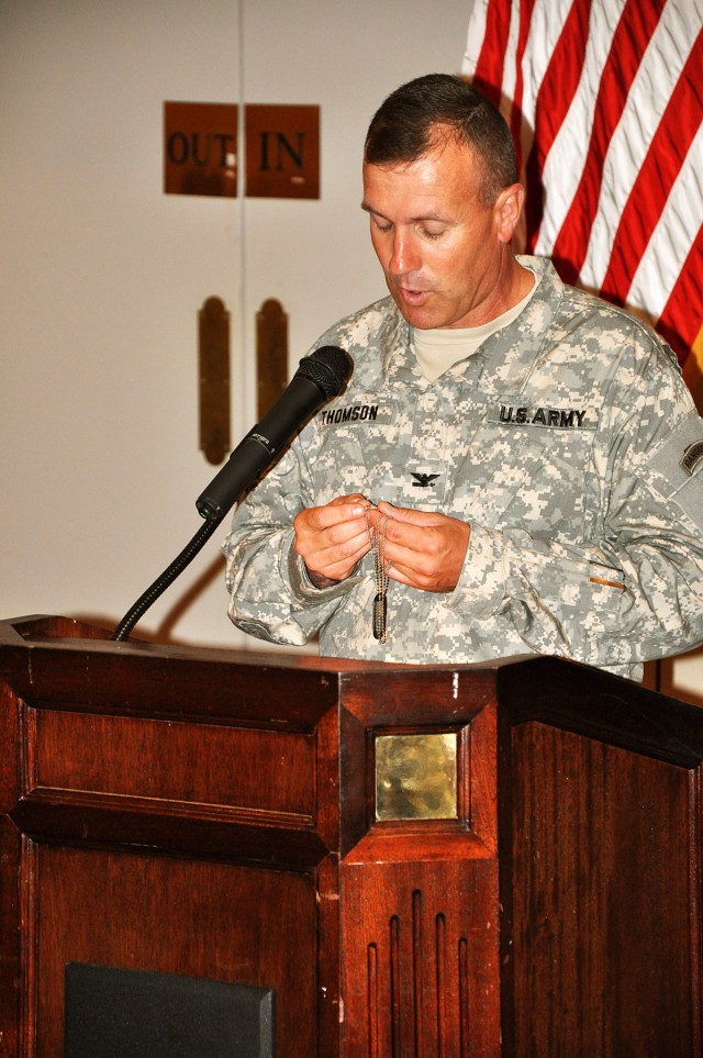 FORT HOOD, Texas-Col. John Thomson, brigade commander for the 41st Fires Brigade, holds his identification tags, given to him by Chaplain (Lt. Col.) Barbara Sherer, chaplain for the 1st Cav. Div., as he introduces her for the spiritual fitness lunche...