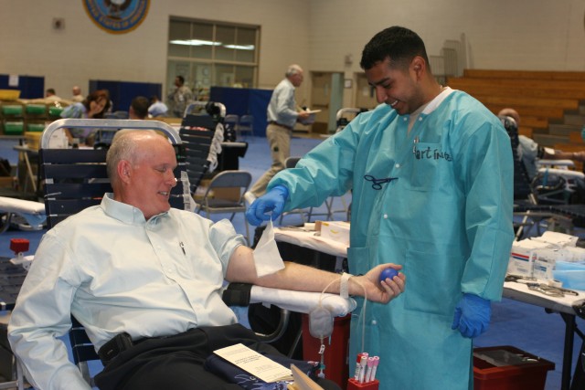 Spc. Abdiel Martinez, medical lab technician, Armed Services Blood Program, Fort Bliss, Texas, prepares to collect blood from Mark Pitts, a civilian employee on Fort Huachuca. ASBP can only collect blood from members of the military community to...