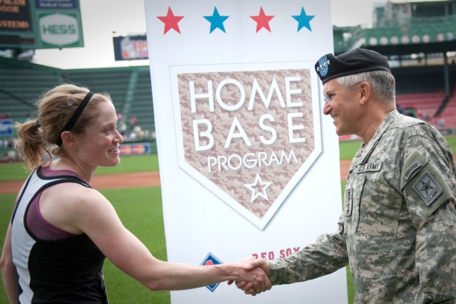 Chief of Staff of the Army, Gen. George W. Casey Jr., congratulates a runner after she finishes the first annual Run to Home Base 9K run in Boston, Mass., May 23, 2010.  Over 2,000 runners ran and raised 2.4 million dollars to support the Home Base p...