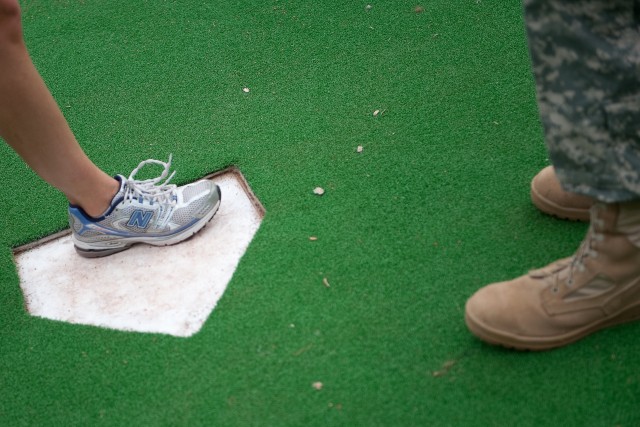 A runner touches Fenway Park's home-plate during the first annual Run to Home Base 9K run in Boston, Mass., May 23, 2010.  Over 2,000 runners ran and raised 2.4 million dollars to support the Home Base program that helps veterans returning from Iraq ...