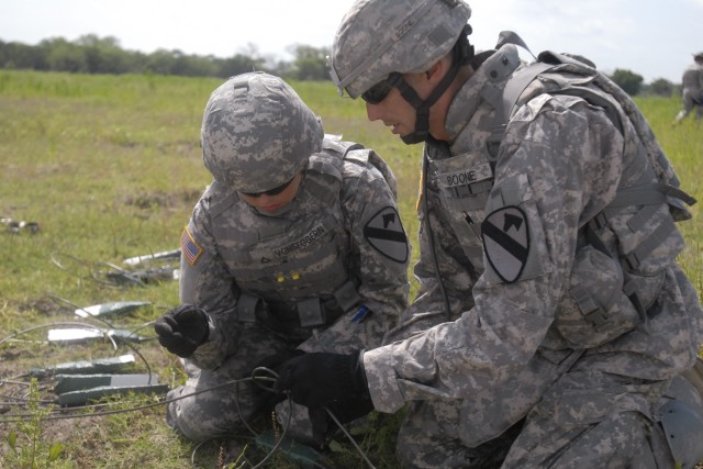 FORT HOOD, Texas - Spc. Adam Boone (right) demonstrates how to tie a girth hitch knot with an extra turn to a ring main to Pfc. Sydney Von Seggern, a medic assigned to Headquarters and Headquarters Company, 3rd Brigade Special Troops Battalion,...