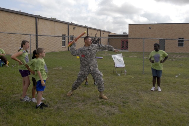 FORT HOOD, Texas-Moreno, Valley, Calif. Native, Spc. Freddy Rodriguez, from A Battery, 2nd Battalion, 82nd Field Artillery Regiment, 3rd Brigade Combat Team, 1st Cavalry Division, prepares to throw a javelin as students at Halstead Elementary School ...