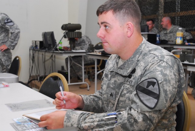 FORT HOOD, Texas-Sgt. Shane Green, a Victoria, Texas native and a team chief with Headquarters and Headquarters Company, 1st Battalion, 5th Cavalry Regiment, 2nd Brigade Combat Team, 1st Cavalry Division, plots grids on a map during call for fire...