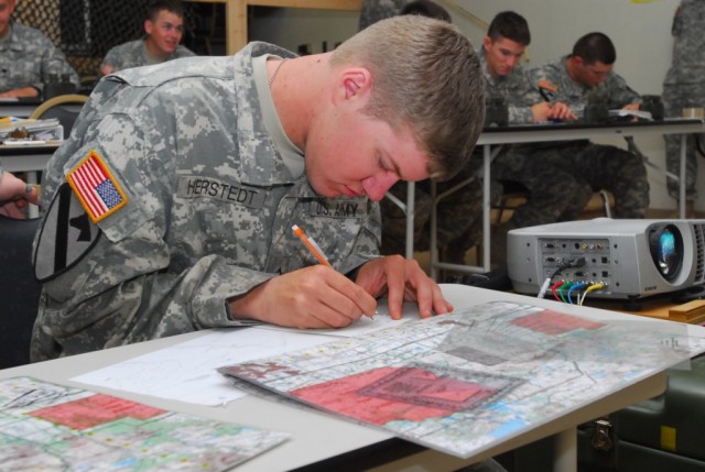 FORT HOOD, Texas-Pfc. Luke Herstedt, from Alliance, Neb., a forward observer with Headquarters and Headquarters Company, 1st Battalion, 5th Cavalry Regiment, 2nd Brigade Combat Team, 1st Cavalry Division, looks over a map as he prepares to...
