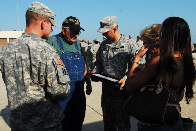 FORT HOOD, Texas-Sgt. 1st Class Cheyenne Barber (center), a platoon sergeant with the 2nd Special Troops Battalion, 2nd Brigade Combat Team, 1st Cavalry Division, looks over the certificates presented to his grandpa, Dean Scantling, during a...