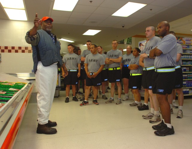 FORT HOOD, Texas - Allen Hart (left), a meat cutter for the Clear Creek Commissary, explains to a group of single Soldiers the benefits of buying fresh cuts of meat during a Better Opportunity for Single Soldiers tour, May 11.. He also discusses wher...