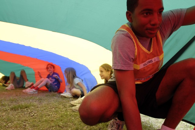 KILLEEN, Texas-Spc. Julius Williams, 215th Brigade Support Battalion, 3rd Brigade Combat Team, 1st Cavalry Division, traps air inside a parachute at Bellaire Elementary School, May 7, as part of a field day. Events like these connect the Soldiers...