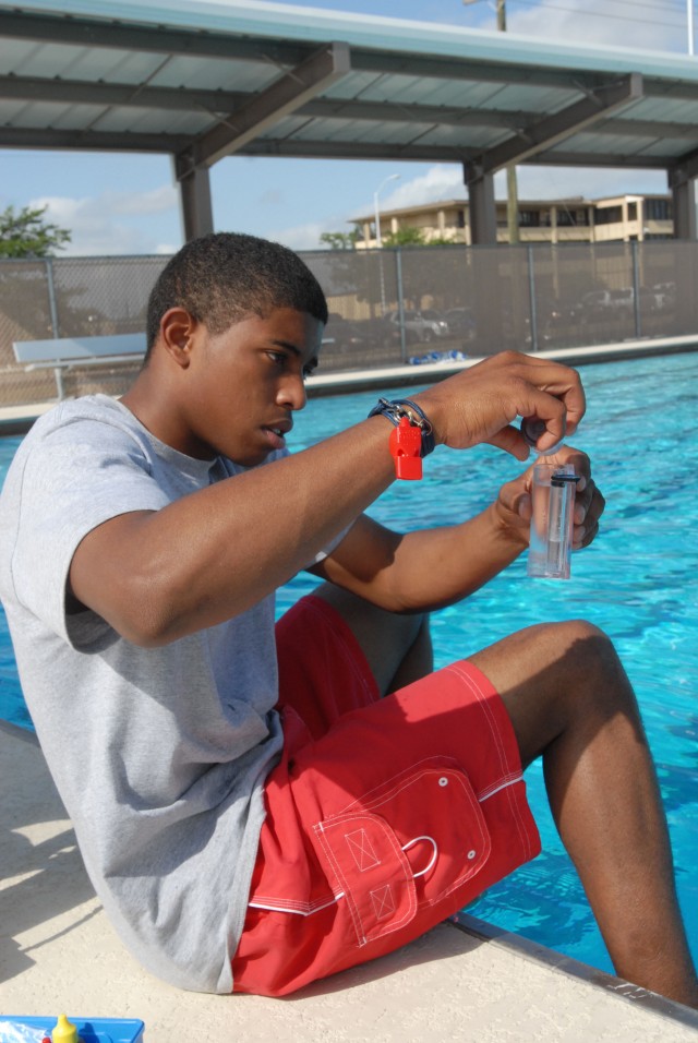 Fort Hood, Texas-Pfc. Anthony Tapia, of Manhatten, N.Y., a supply specialist for Battery C, 1st Battalion 21 Field Artillery Regiment, checks the Ph balance at the 41st Fires Brigade sponsored pool, May 24. The pool will open, May 28,  to valid  mili...