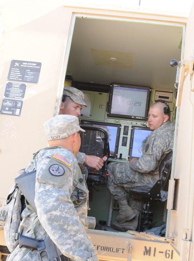 Soldiers man UAV work station