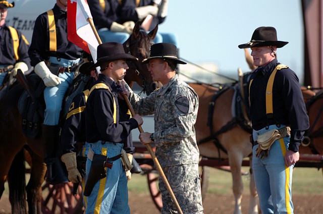 FORT HOOD, Texas-Maj. Gen. Daniel Allyn (center), 1st Cavalry Division's commanding general, hands Capt. David Jackson, of Jacksonville, Texas, the unit guidon, during the Horse Cavalry Detachment's Change-of-Command ceremony May 27, as Jackson takes...