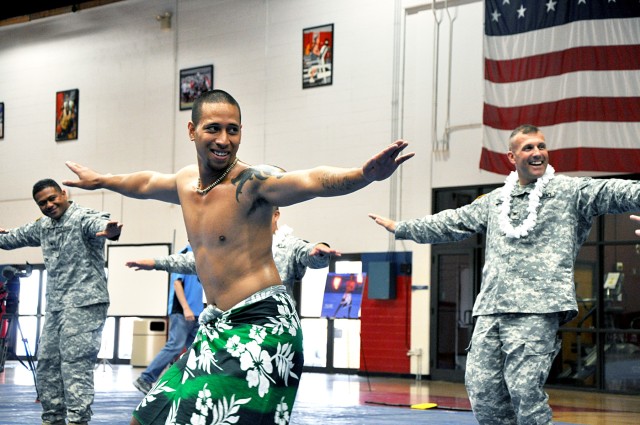FORT HOOD, Texas-The Polynesian dance team Baila Pacifica Entertainment drew the crowd in to participate with one of the traditional dance numbers during the Asian/Pacific-Islander Heritage Month observance May 27. Col. John Thomson (back right),...