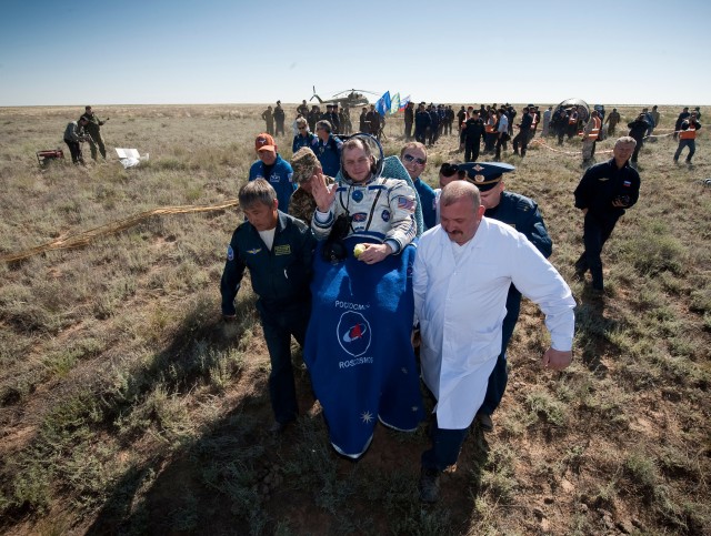 NASA astronaut T.J. Creamer, Expedition 23 flight engineer, is carried in a chair to the medical tent just minutes after he and fellow crew members Russian cosmonaut Oleg Kotov and Japanese astronaut Soichi Noguchi landed in their Soyuz TMA-17...