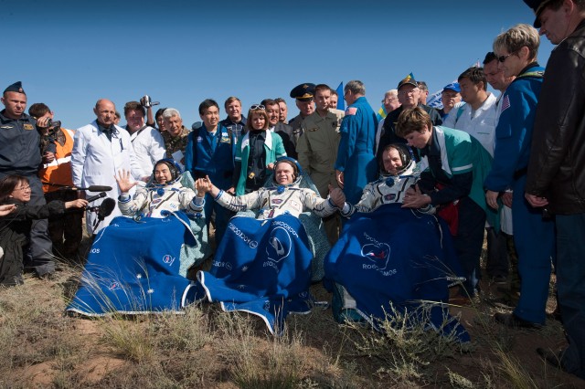 Three Expedition 23 crew members have just been seated in chairs near their Soyuz TMA-17 spacecraft just minutes after they landed near the town of Zhezkazgan, Kazakhstan, on June 2, 2010. In the chairs, from the left, are Japan Aerospace...