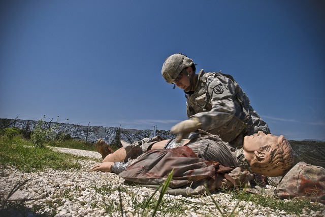 FORT HOOD, Texas-Wharton, Texas native, Sgt. Timothy Long, a shop foreman with the 2nd battalion, 20th Field Artillery Regiment, 41st Fires Brigade, removes the flack vest from a simulated casualty during the 1st Cavalry Division, Non Commissioned...