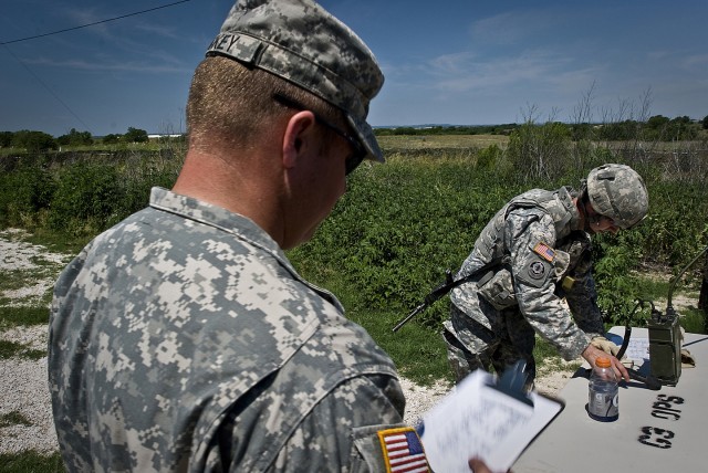 FORT HOOD, Texas-With the casualty now moved to safety, Sgt. Timothy Long (right), from Wharton, Texas, performs a nine line medical evacuation procedure for his simulated casualty, June 1. Correctly calling in a nine-line MEDEVAC can be one of...