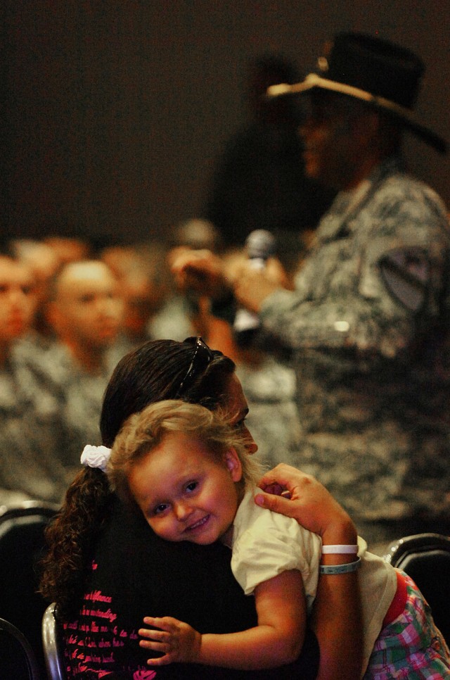 FORT HOOD, Texas - Anna Baskins leans on her mother Danielle Baskins, June 8, at the Phantom Warrior Center while Command Sgt. Maj. James Norman, 1st BCT, 1st Cav. Div., talks about the traditions and standards of the 1st Cav. Div. at the...