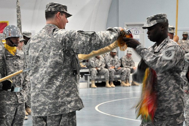 Col. Larry Phelps, the commander of the 15th Sustainment Brigade, and Command Sgt. Maj. Nathaniel Bartee Sr., the brigade's senior noncommissioned officer, case the brigade's colors during a transfer of authority ceremony May 25 at Joint Base...