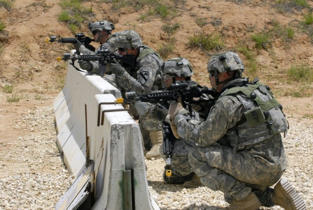 FORT POLK, La. - Soldiers assigned to the A Battery, 5th Battalion, 82nd Field Artillery Regiment, 4th Brigade Combat Team, 1st Cavalry Division, pull security in front of an entry control point during a combat outpost training exercise at the...