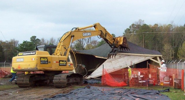 Environmental cleanup contractors demolish shed
