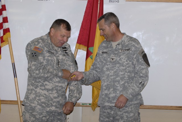 FORT POLK, La. - Col. Brian Winski (right), commander of the 4th Brigade Combat Team, 1st Cavalry Division, gives Gen. James Thurman, commander of United States Army Forces Command, a coin of excellence after visiting with the brigade during their Jo...