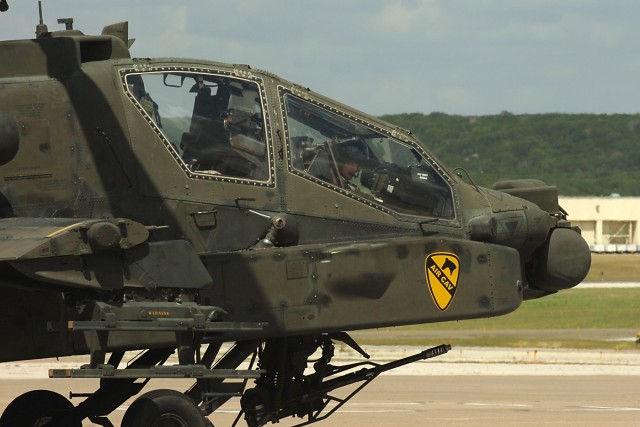 FORT HOOD, Texas-Col. Douglas Gabram (right), from Cleveland, Ohio, commander, 1st Air Cavalry Brigade, 1st Cavalry Division, looks out from the front seat of an AH-64D Apache attack helicopter after landing at Robert Gray Army Airfield, June 15. It ...