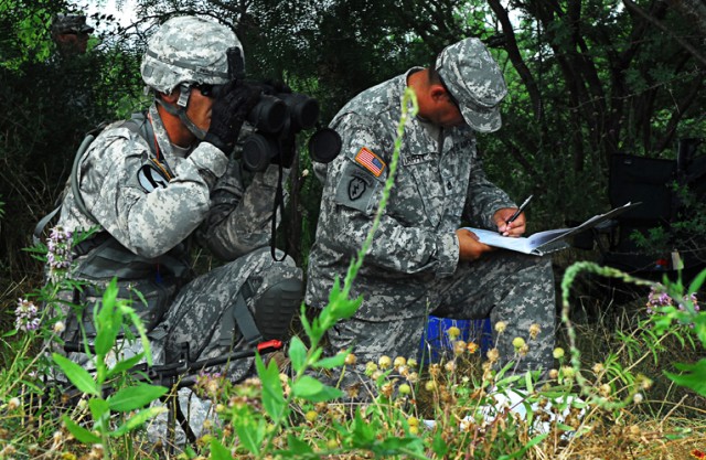 FORT HOOD, Texas- Spc. Don Pierce (left), an infantryman with 1st Battalion, 8th Cavalry Regiment, 2nd Brigade Combat Team, 1st Cavalry Division, checks the distance of his target before simulating calling for fire during Expert Infantryman Badge...