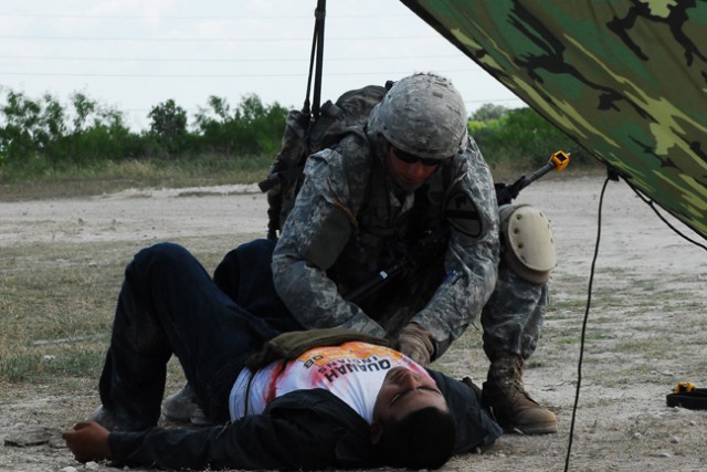 FORT HOOD, Texas- Sgt. Jake Berger, an infantryman with 1st Battalion, 12th Cavalry Regiment, 3rd Brigade Combat Team, 1st Cavalry Division, demonstrates the proper technique of treating a chest wound on a casualty during Expert Infantryman Badge...