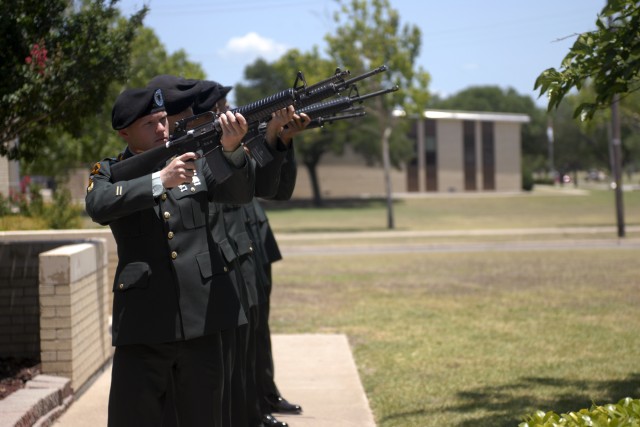 FORT HOOD, Texas-The firing party for Headquarters and Headquarters Troop, 3rd Brigade Combat Team, 1st Cavalry Division, renders a three volley salute at the memorial service for Spc. Robert Rose, June 22, on Fort Hood. Rose was the unit's driver...