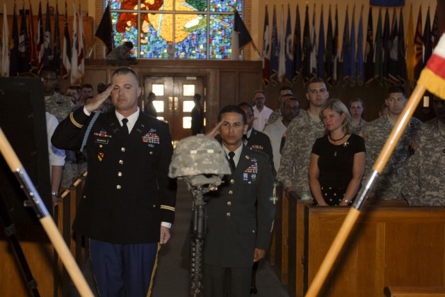 FORT HOOD, Texas-Capt. David McCarthy (left) and 1st Sgt. Jorge Velez, the command team of Headquarters and Headquarters Troop, 3rd Brigade Combat Team, 1st Cavalry Division, render honors to Spc. Robert Rose, the unit's chemical, biological,...