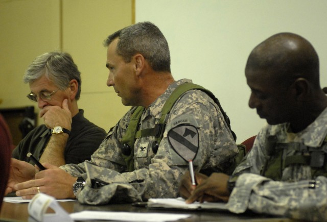 FORT POLK, La.- Col. Brian Winski (center), commander, 4th Brigade Combat Team, 1st Cavalry Division, speaks with Secretary of the Army, the Honorable John McHugh, about his brigade's training during their Joint Training Readiness Training Center rot...