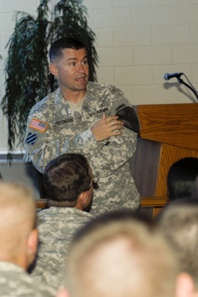 FORT HOOD, Texas-Col. Douglas Crissman, the commander of 3rd Brigade Combat Team, 1st Cavalry Division, refers to the 1st Cavalry Division patch as he talks to new "Greywolf" Soldiers about the heritage and pride of the unit during a brief, June...