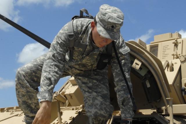 FORT HOOD, Texas- Spc. Jesus Salazar, from Mundelein, Ill., exits a Bradley Fighting Vehicle during sustainment training, June 25, at 6th Squadron, 9th Cavalry Regiment, 3rd Brigade Combat Team, 1st Cavalry Division's motor pool. Salazar is a BFV...