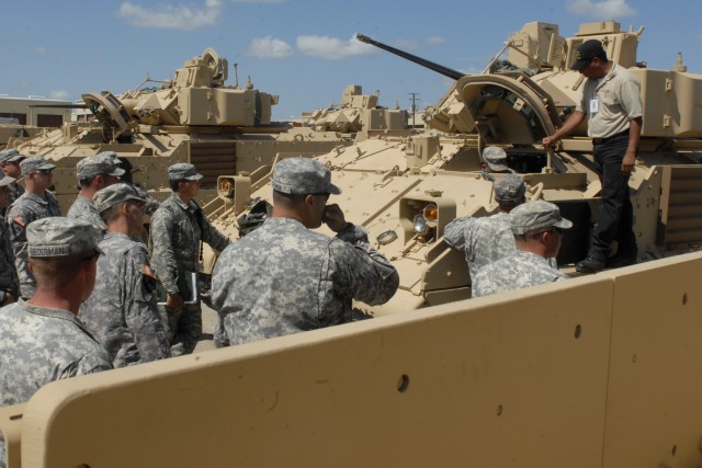 FORT HOOD, Texas-Troopers from 6th Squadron, 9th Cavalry Regiment, 3rd Brigade Combat Team, 1st Cavalry Division crowd around a Bradley Fighting Vehicle as Chris Gonzales, an instructor from BAE Systems explains the procedures for jump-starting a...