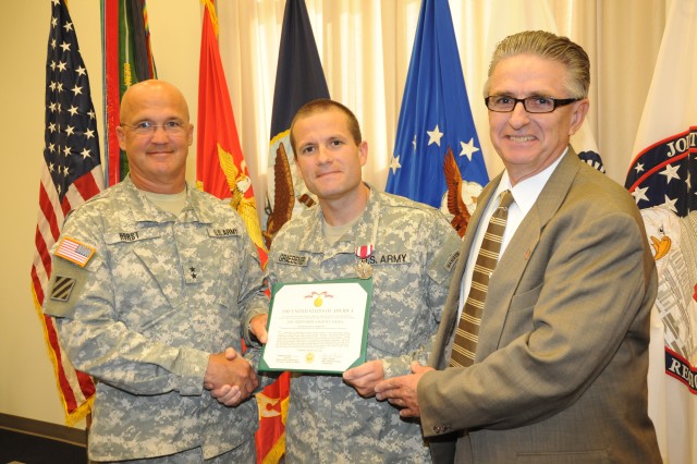 Maj. Jonathan Graebener receives farewell award Story by Adrienne M. Combs, Deputy Public Affairs Officer