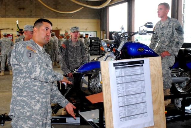 FORT HOOD, Texas- Sgt. 1st Class Carlos Gomez, from Laredo, Texas, a scout platoon sergeant with 2nd Special Troops Battalions, 2nd Brigade Combat Team, 1st Cavalry Division, demonstrates how the body moves when turning corners on a motorcycle during...