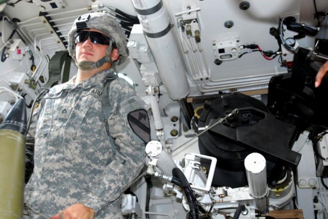 FORT HOOD, Texas- Pfc. Bryan Zimmerman, a Colombia, Tenn. native and a canon crew member with 3rd Battalion., 82nd Field Artillery Regiment, 2nd Brigade Combat Team, 1st Cavalry Division, pulls the cord on a self-propelled, 155mm howitzer during trai...