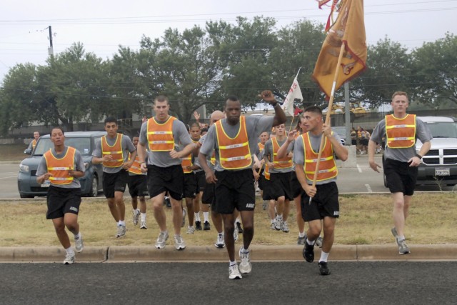 FORT HOOD, Texas-Lt. Col. James Smith (center), the commander of 215th Brigade Support Battalion, 3rd Brigade Combat Team, 1st Cavalry Division, leads a formation of his Soldiers, June 30. The battalion celebrated its 39th birthday with a formation r...