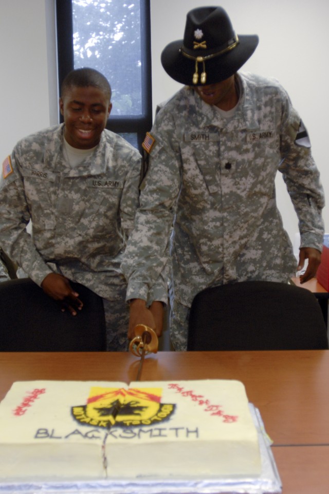 FORT HOOD, Texas-Pvt. Derrick Harris (left), a cook from Villa Rica, Ga., the youngest Soldier in 215th Brigade Support Battalion, 3rd Brigade Combat Team, 1st Cavalry Division, helps cuts the battalion's 39th birthday cake with the unit's commander,...
