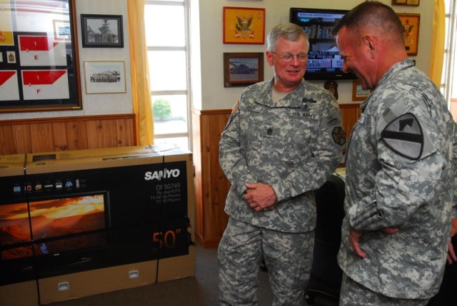 FORT HOOD, Texas- Col. John Peeler (right), commander, 2nd Brigade Combat Team, 1st Cavalry Division, talks to Command Sgt. Maj. Donald Felt, Fort Hood garrison command, July 6 about the success of the Fort Hood Single Soldiers' Festival, which...