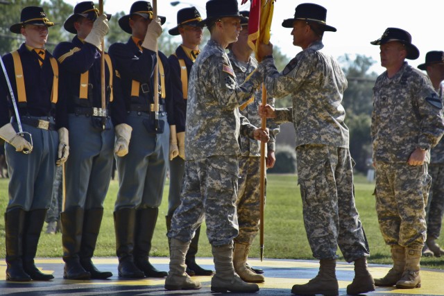 FORT HOOD, Texas-During the 1st Air Cavalry Brigade, 1st Cavalry Division's change of command ceremony, Brig. Gen. Daniel Allyn (center), commander, 1st Cav. Div., transfers 1st ACB's colors from Col. Douglas Gabram (right), of Cleveland, former...