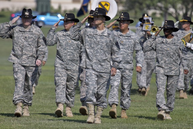 FORT HOOD, Texas-Col. John Novalis II (center), the newly-minted commander of the 1st Air Cavalry Brigade, 1st Cavalry Division, from Willamsport, Pa., salutes Brig. Gen. Daniel Allyn (off frame left), commander of the 1st Cav. Div., as he leads his ...